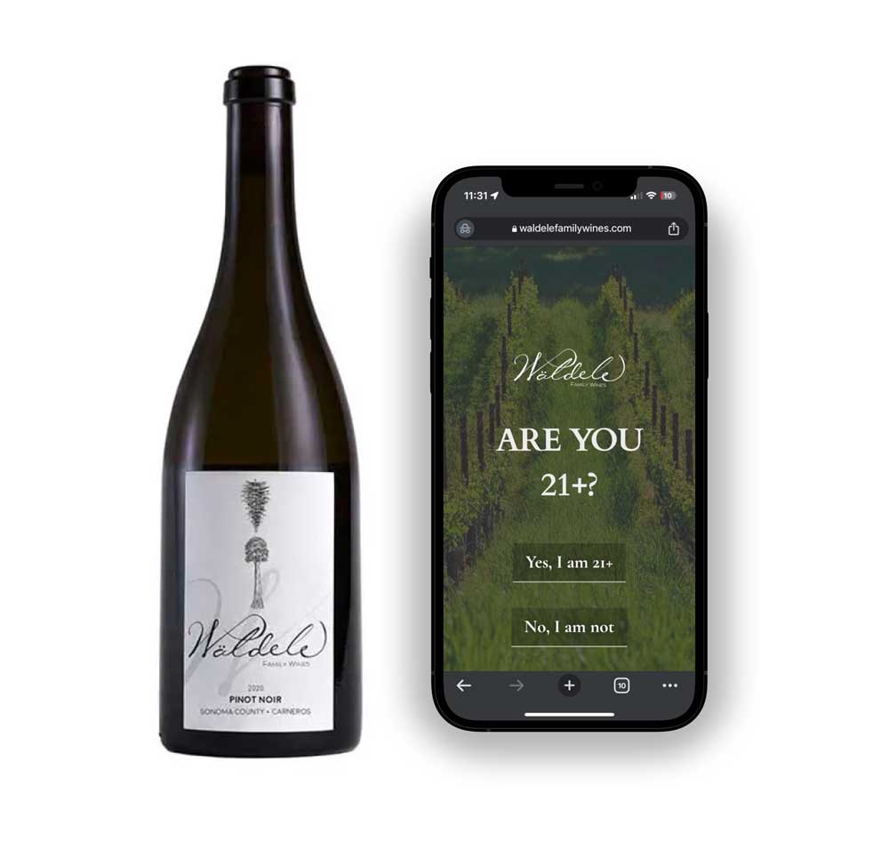 A wine bottle and a phone with a website that says are you 21? Yes or no?
